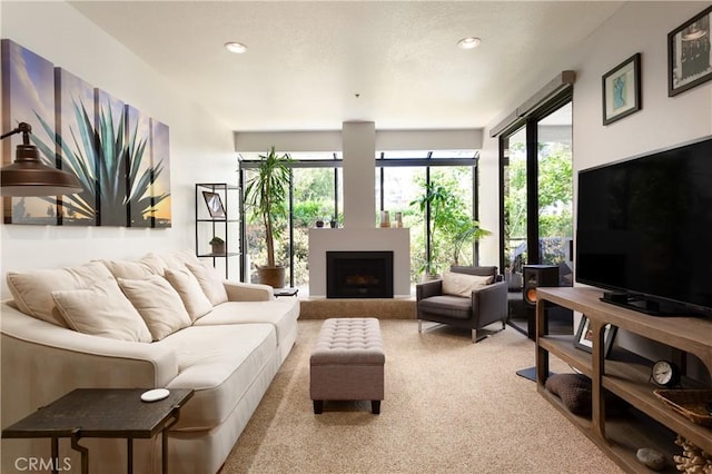 270 Cagney Ln Unit 215, Newport Beach, CA 92663 - carpeted living room with recessed lighting and a fireplace