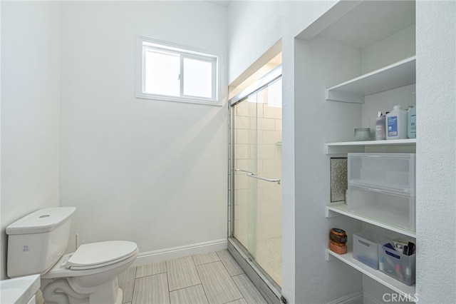 38740 25th St E, Palmdale, CA 93550 - bathroom featuring toilet, a stall shower, and baseboards