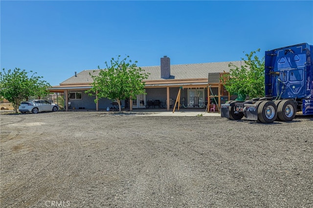 38740 25th St E, Palmdale, CA 93550 - view of front facade with a chimney, a tiled roof, and a patio