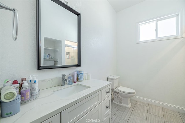 38740 25th St E, Palmdale, CA 93550 - bathroom with toilet, baseboards, and vanity