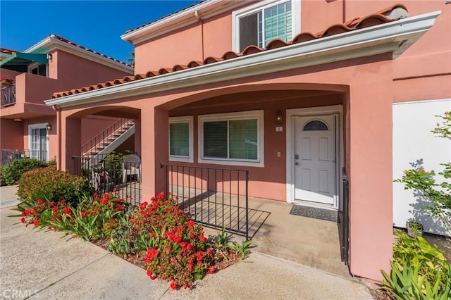 409 Utica Ave Unit 1A, Huntington Beach, CA 92648 - doorway to property featuring stucco siding and covered porch