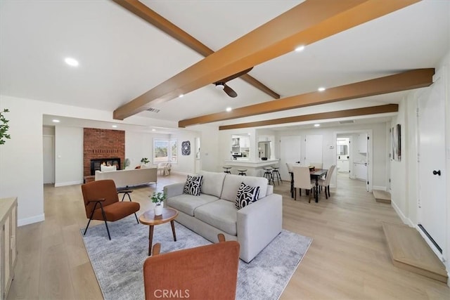18710 Corwin Rd, Apple Valley, CA 92307 - living room with beamed ceiling, light wood-style flooring, recessed lighting, baseboards, and a fireplace