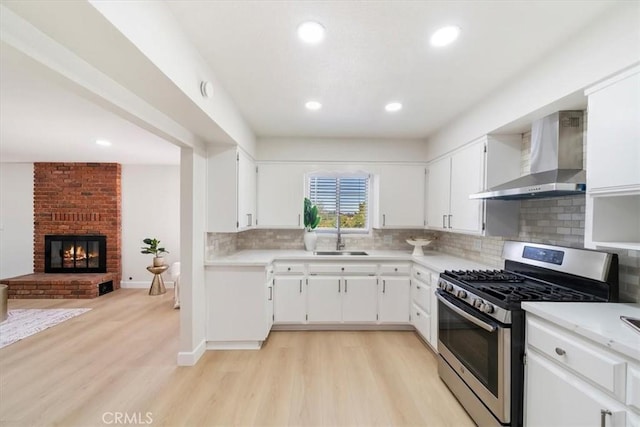 18710 Corwin Rd, Apple Valley, CA 92307 - kitchen featuring wall chimney exhaust hood, gas range, a sink, light countertops, and recessed lighting