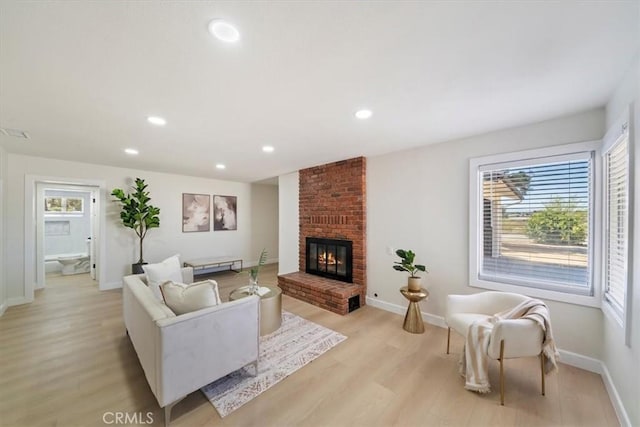 18710 Corwin Rd, Apple Valley, CA 92307 - living room with light wood finished floors, a fireplace, baseboards, and recessed lighting