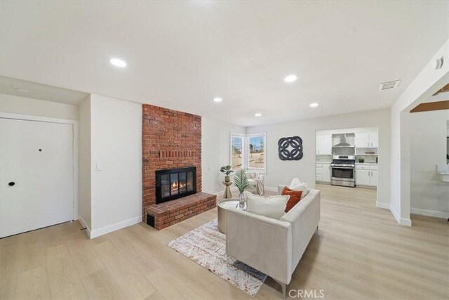 18710 Corwin Rd, Apple Valley, CA 92307 - living area featuring light wood-type flooring, a fireplace, recessed lighting, and baseboards