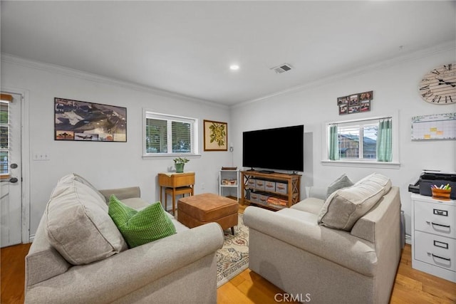 living area with crown molding, light wood-style floors, and recessed lighting
