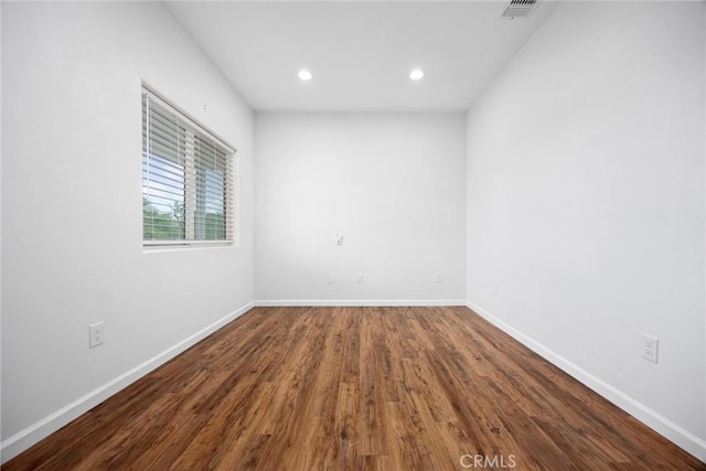 unfurnished room with recessed lighting, baseboards, and wood finished floors