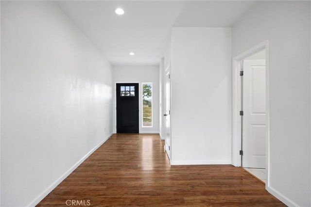 doorway to outside with wood finished floors, recessed lighting, and baseboards