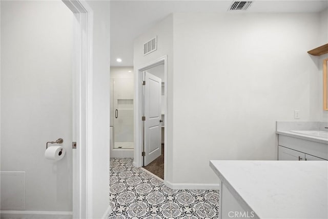 bathroom with a shower stall, vanity, baseboards, recessed lighting, and tile patterned flooring