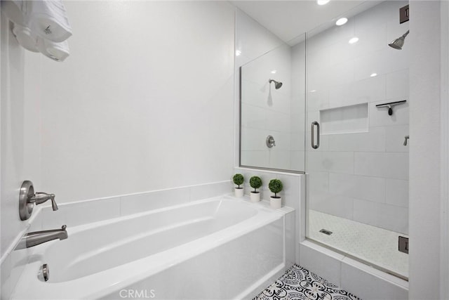 full bathroom with a garden tub, a stall shower, and tile patterned flooring