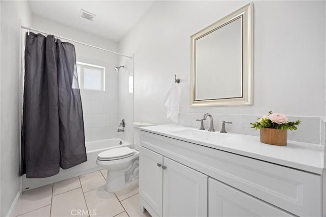 bathroom featuring toilet, vanity, shower / bath combo with shower curtain, and tile patterned floors