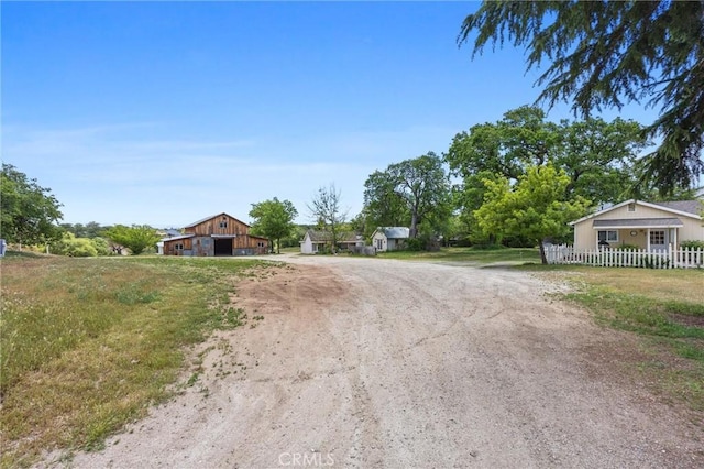 view of dirt / gravel road with a barn