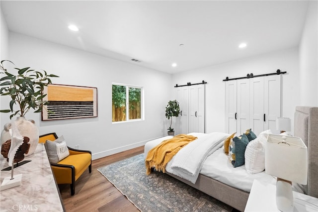 160 S Altadena Dr, Pasadena, CA 91107 - bedroom featuring a barn door, wood finished floors, recessed lighting, and baseboards