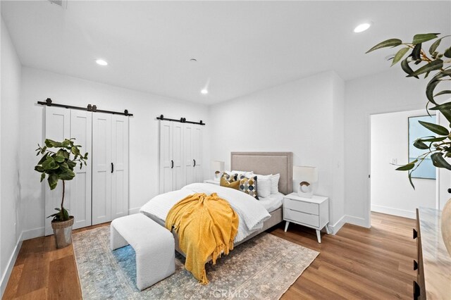 160 S Altadena Dr, Pasadena, CA 91107 - bedroom with a barn door, wood finished floors, baseboards, and recessed lighting