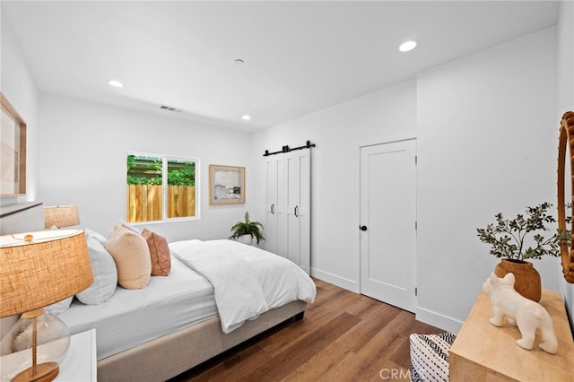 160 S Altadena Dr, Pasadena, CA 91107 - bedroom featuring wood finished floors, a barn door, recessed lighting, and multiple closets
