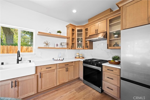 160 S Altadena Dr, Pasadena, CA 91107 - kitchen featuring gas stove, freestanding refrigerator, under cabinet range hood, a sink, and light brown cabinets