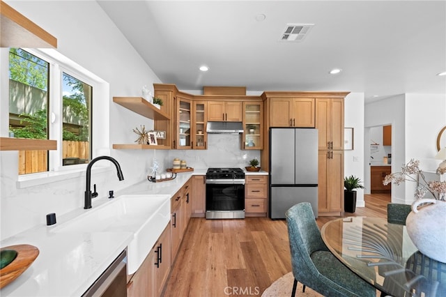 160 S Altadena Dr, Pasadena, CA 91107 - kitchen with range with gas stovetop, freestanding refrigerator, under cabinet range hood, a sink, and light wood-style floors
