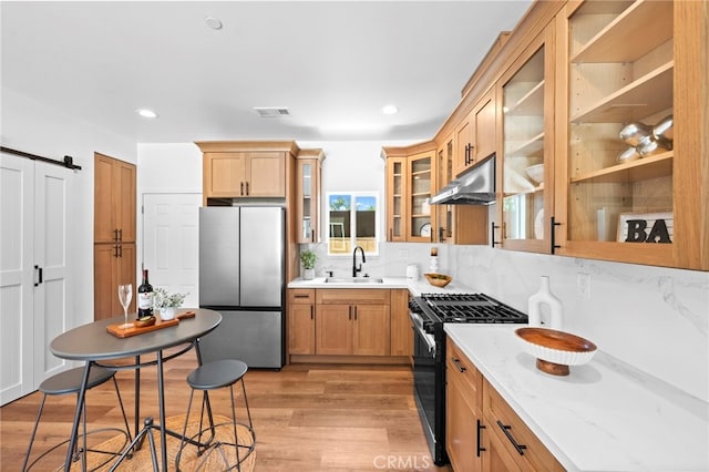 160 S Altadena Dr, Pasadena, CA 91107 - kitchen with stainless steel appliances, under cabinet range hood, a sink, light wood-type flooring, and decorative backsplash