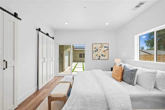 160 S Altadena Dr, Pasadena, CA 91107 - bedroom with a barn door, light wood finished floors, recessed lighting, and baseboards