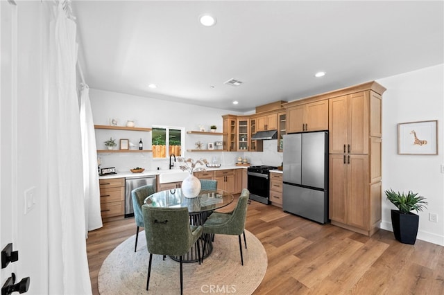 160 S Altadena Dr, Pasadena, CA 91107 - kitchen with stainless steel appliances, open shelves, under cabinet range hood, a sink, and light countertops