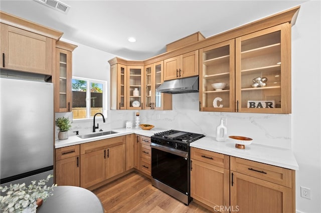 160 S Altadena Dr, Pasadena, CA 91107 - kitchen featuring freestanding refrigerator, under cabinet range hood, range with gas stovetop, a sink, and tasteful backsplash