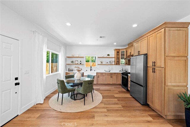 160 S Altadena Dr, Pasadena, CA 91107 - kitchen with open shelves, freestanding refrigerator, gas stove, light wood-type flooring, and light brown cabinets