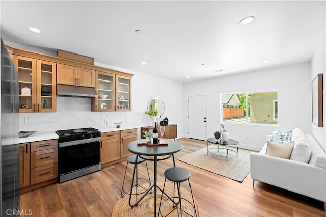 160 S Altadena Dr, Pasadena, CA 91107 - kitchen with range with gas stovetop, under cabinet range hood, open floor plan, wood finished floors, and recessed lighting