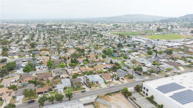 view of property location featuring a mountain backdrop and nearby suburban area