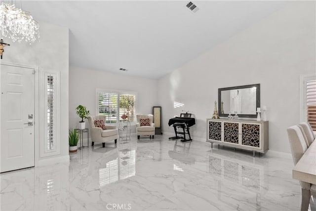 4064 Prestwick Ln, Palmdale, CA 93551 - entryway with marble tiled flooring, high vaulted ceiling, baseboards, and a chandelier