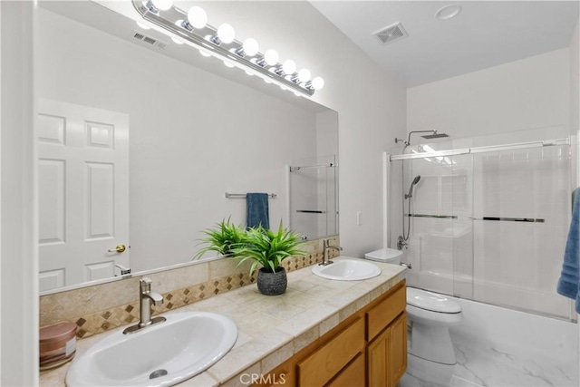 4064 Prestwick Ln, Palmdale, CA 93551 - full bath with double vanity, toilet, enclosed tub / shower combo, and marble look tile flooring