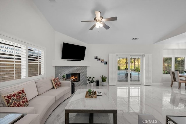 4064 Prestwick Ln, Palmdale, CA 93551 - living room featuring lofted ceiling, marble tiled flooring, a ceiling fan, and a tile fireplace
