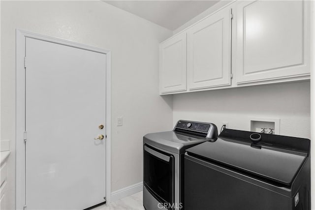 4064 Prestwick Ln, Palmdale, CA 93551 - laundry room with cabinet space, washing machine and dryer, light marble finish floors, and baseboards