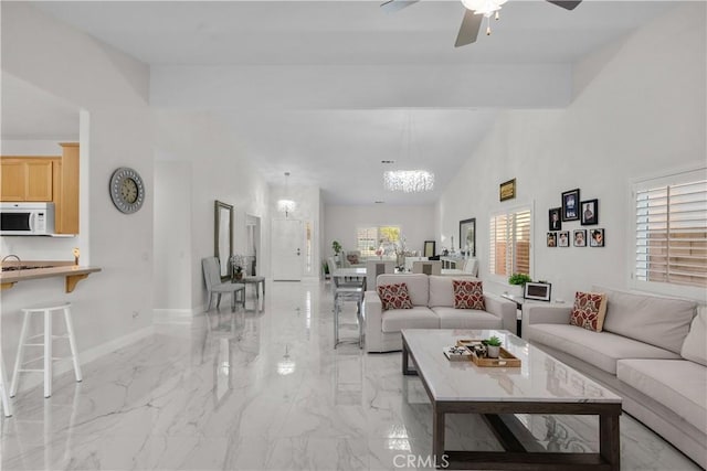 4064 Prestwick Ln, Palmdale, CA 93551 - living room with light marble finish flooring, a chandelier, ceiling fan, and baseboards