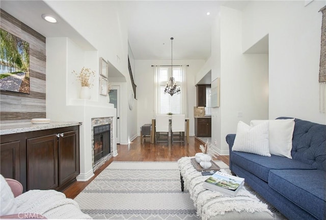 11 Via Pamplona, Rancho Santa Margarita, CA 92688 - living room with dark wood-style flooring, a fireplace, a chandelier, baseboards, and recessed lighting