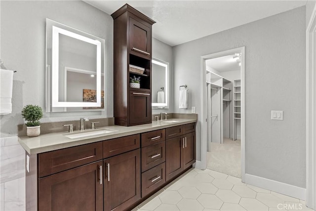 30 Yorktown, Irvine, CA 92620 - full bathroom with double vanity, a spacious closet, tile patterned flooring, and baseboards