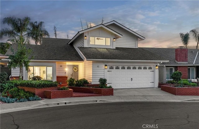 30 Yorktown, Irvine, CA 92620 - view of front facade featuring concrete driveway, brick siding, roof with shingles, and an attached garage