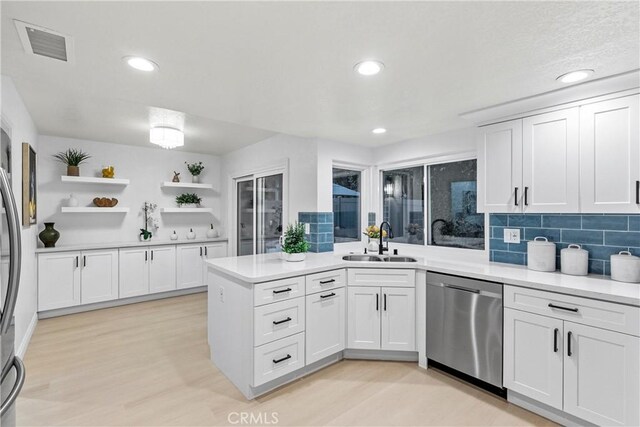 30 Yorktown, Irvine, CA 92620 - kitchen with stainless steel dishwasher, a sink, a peninsula, white cabinetry, and recessed lighting