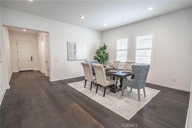 dining area featuring baseboards, dark wood finished floors, and recessed lighting