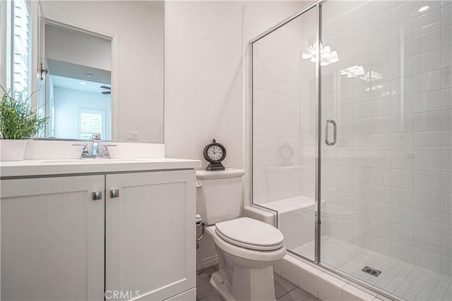 full bathroom with a stall shower, toilet, and vanity