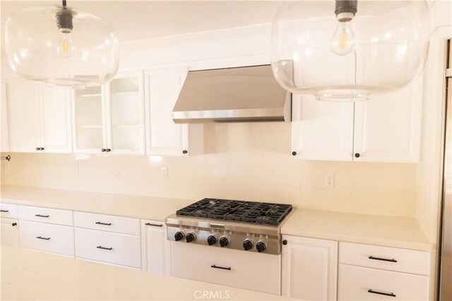 12539 Presnell St, Los Angeles, CA 90066 - kitchen featuring stainless steel gas cooktop, light countertops, white cabinets, decorative backsplash, and wall chimney range hood