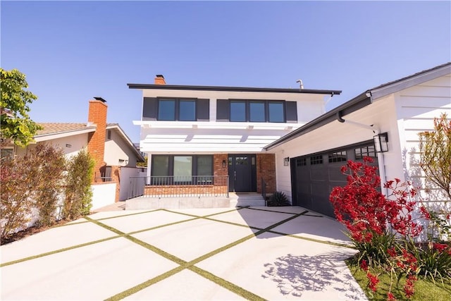 12539 Presnell St, Los Angeles, CA 90066 - view of front of house featuring an attached garage, concrete driveway, covered porch, and brick siding