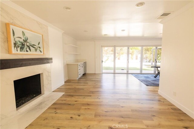 12539 Presnell St, Los Angeles, CA 90066 - unfurnished living room with a high end fireplace, light wood-style floors, baseboards, recessed lighting, and crown molding