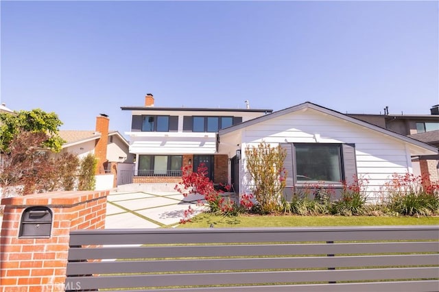 12539 Presnell St, Los Angeles, CA 90066 - view of front of house with a fenced front yard, a chimney, and brick siding