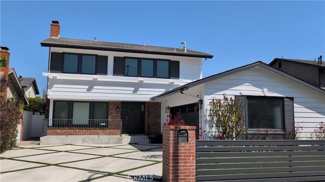 12539 Presnell St, Los Angeles, CA 90066 - view of front of home featuring a fenced front yard, brick siding, an attached garage, and a chimney