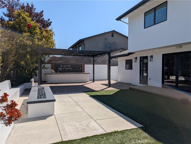 12539 Presnell St, Los Angeles, CA 90066 - view of yard featuring a fire pit, a patio area, and fence