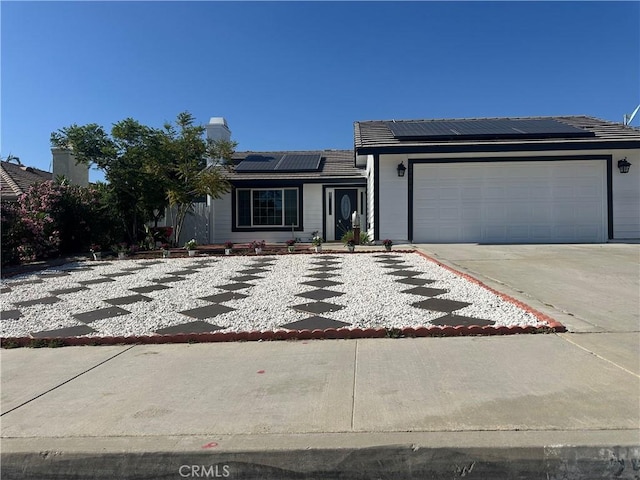 25690 Onate Dr, Moreno Valley, CA 92557 - ranch-style home featuring solar panels, driveway, an attached garage, a chimney, and a tile roof