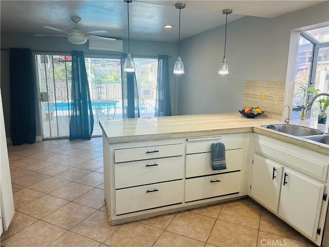 25690 Onate Dr, Moreno Valley, CA 92557 - kitchen featuring a peninsula, light countertops, light tile patterned floors, ceiling fan, and a sink