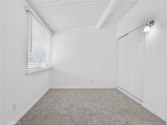15533 Heartsease Ln, Victorville, CA 92395 - carpeted empty room featuring baseboards and beamed ceiling