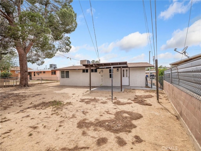 15533 Heartsease Ln, Victorville, CA 92395 - rear view of house featuring a fenced backyard, stucco siding, and a patio