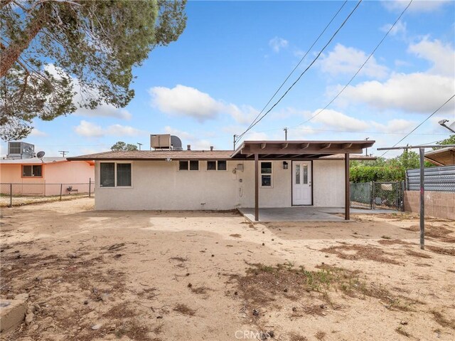 15533 Heartsease Ln, Victorville, CA 92395 - rear view of property with a patio area, fence, stucco siding, and central AC
